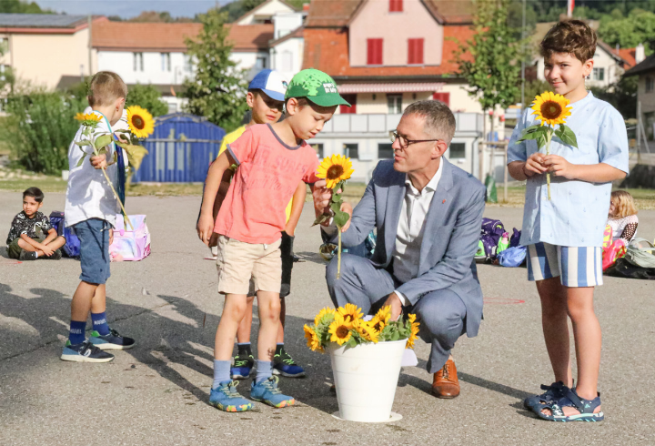 In Langenbruck erhalten Erstklässler von Bildungsdirektor Markus Eigenmann eine Sonnenblume. Bild Pascal Kamber In Langenbruck erhalten Erstklässler von Bildungsdirektor Markus Eigenmann eine Sonnenblume. Bild Pascal Kamber